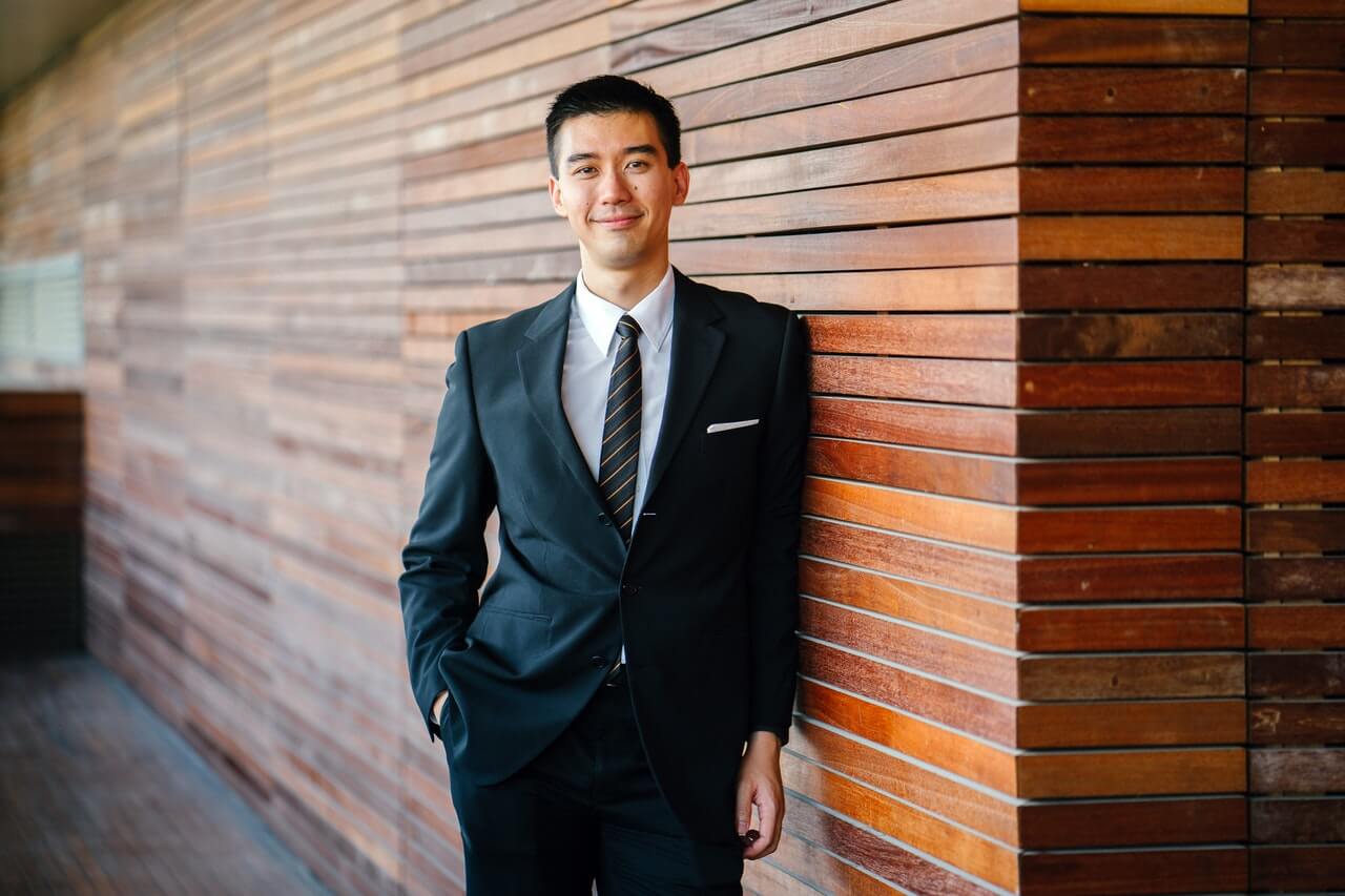 property-managers-for-airbnb-asian-man-wearing-a-smart-suit-smiling